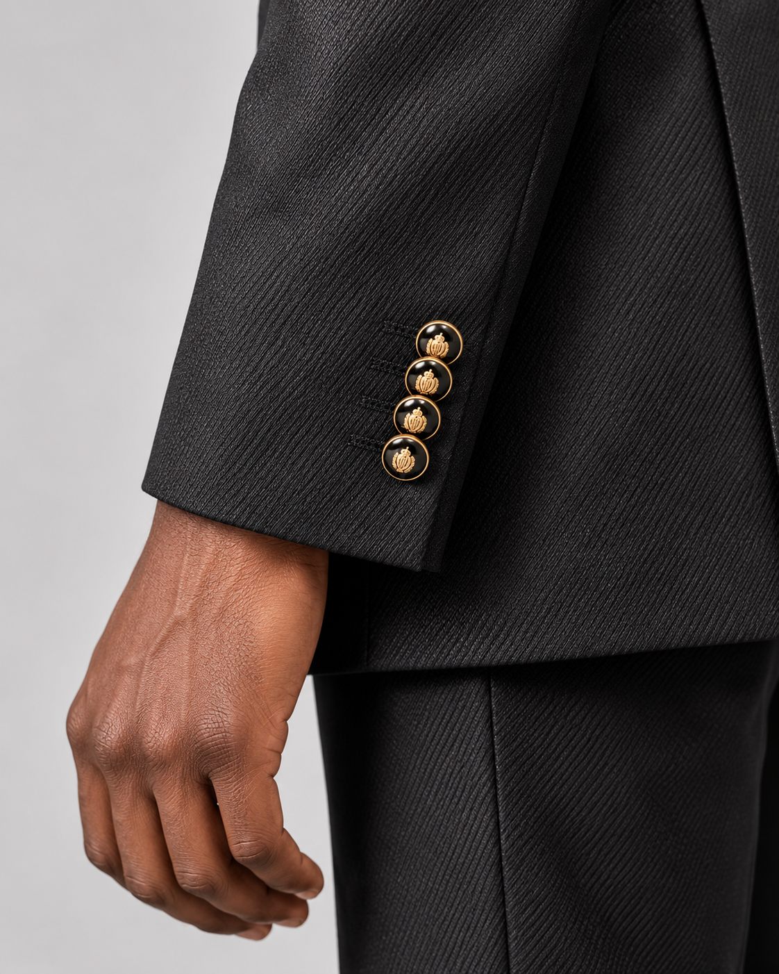Giovanni Testi black banded collar suit sleeve detail with four gold-tone crest buttons