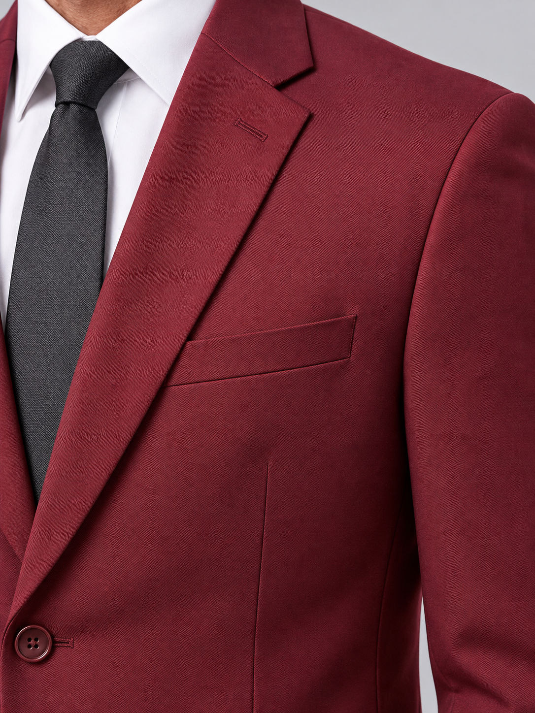 Close-up of the burgundy Pavaratti 203 modern-fit suit showing the notch lapel, chest pocket and fabric texture