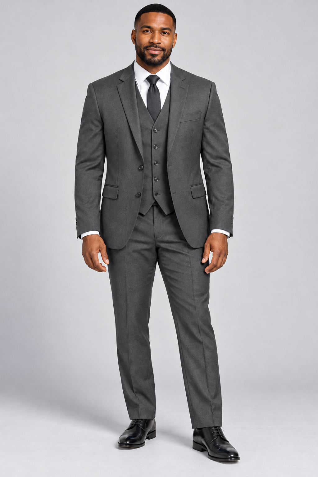 Model wearing the charcoal Pavaratti 203 modern-fit three-piece suit with matching jacket, vest and trousers