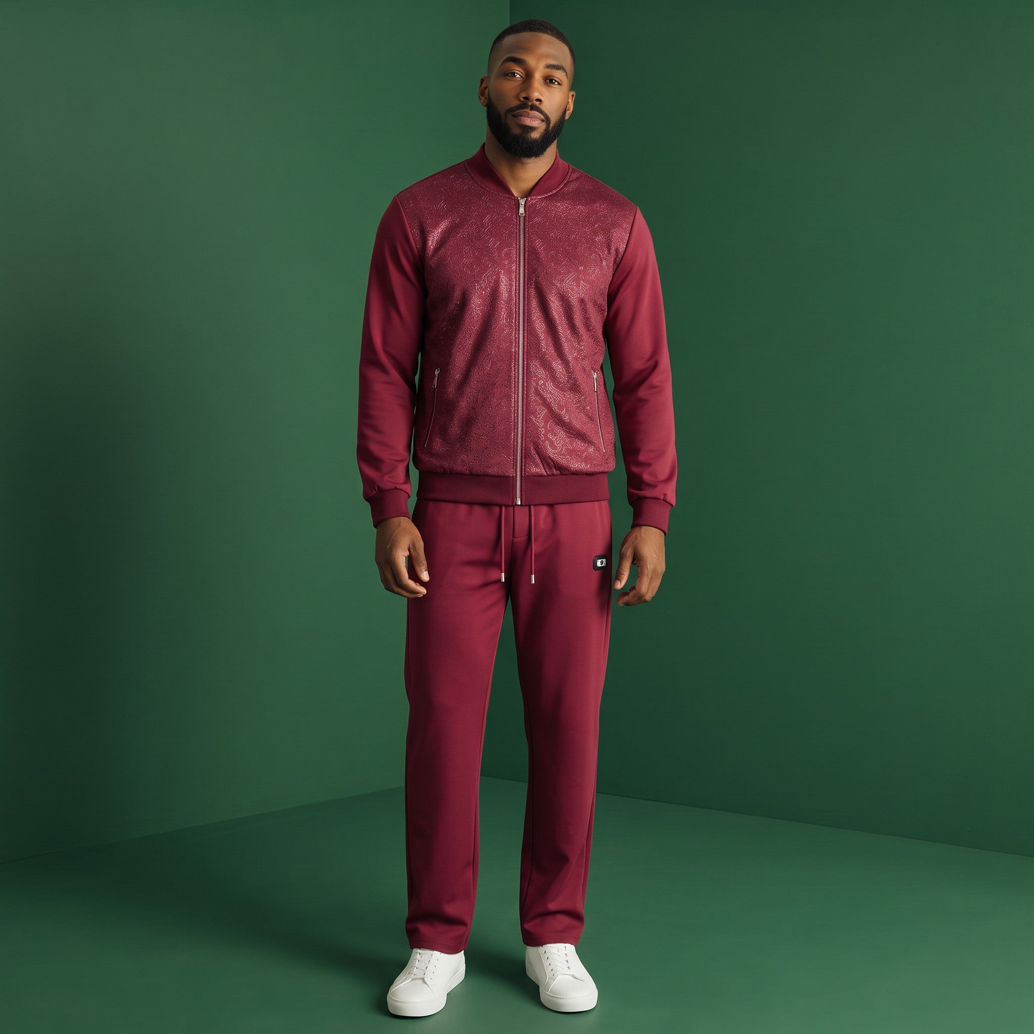 A man wearing a wine-colored Barocco Regalia Emboss Tracksuit from The City Warehouse-Menswear with baroque patterns.
