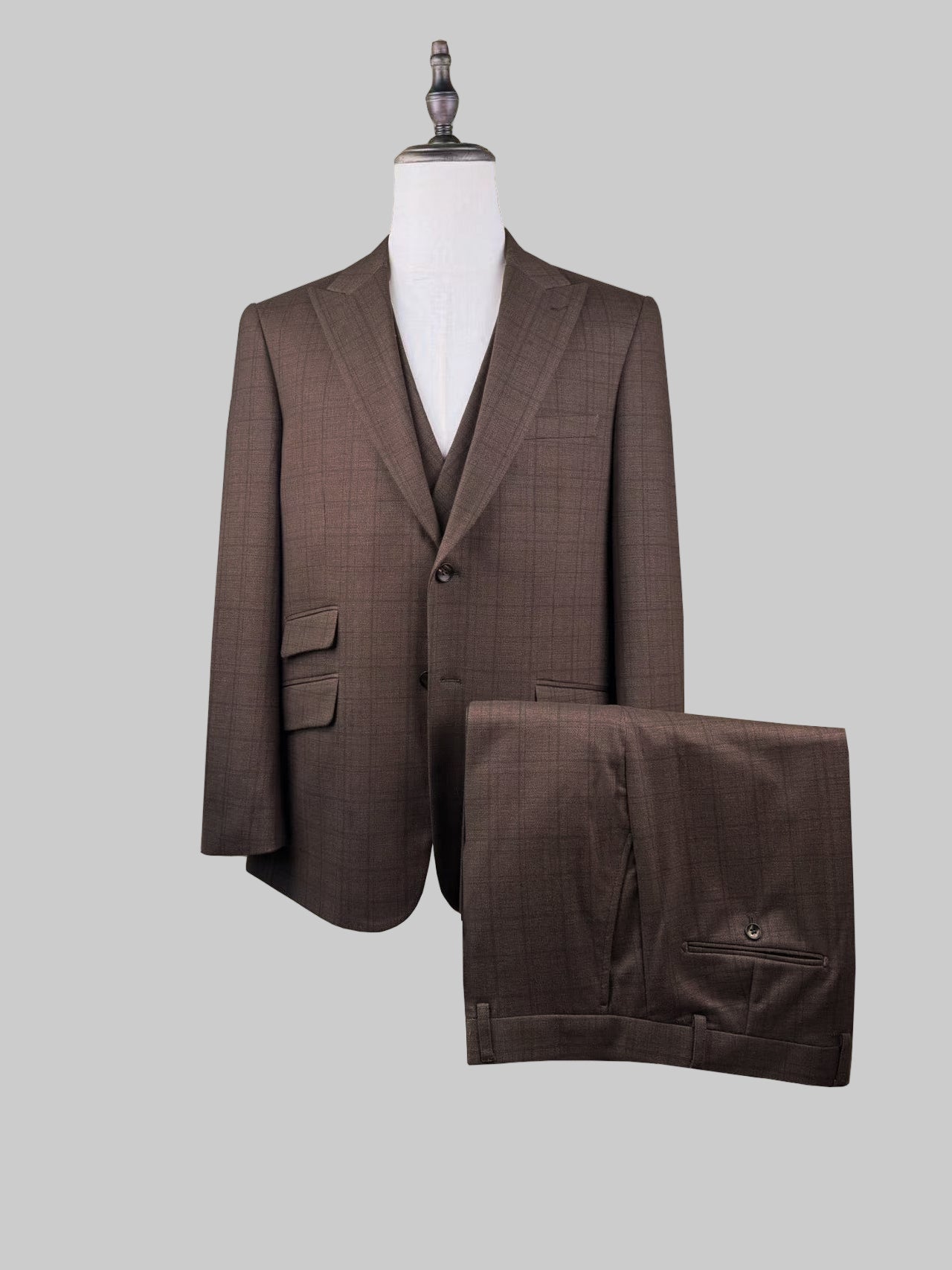 Brown checkered suit on a mannequin with 'NPV-7133 BROWN' label.