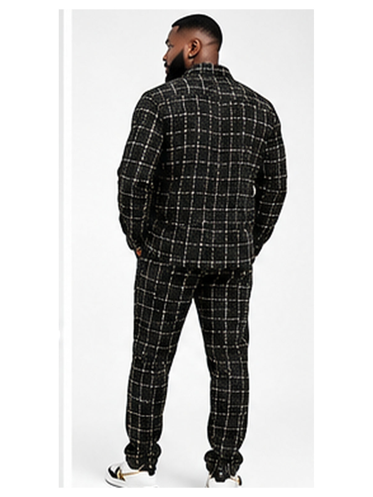Black male model wearing black TRST-513 shirt and pants rear view
