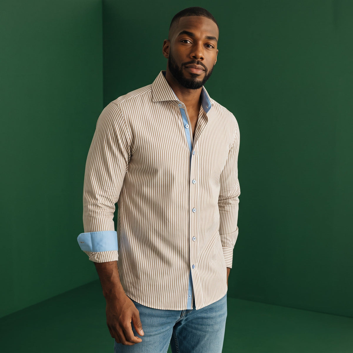 A model wearing a brown and white Bengal-striped 100% cotton Steven Land dress shirt with a spread collar.