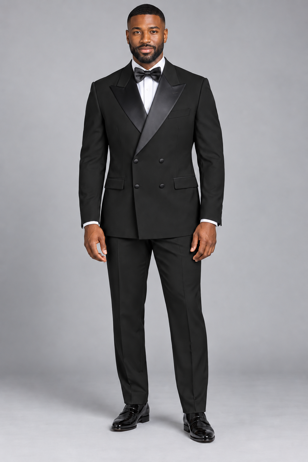 Vinci TDB-900 black solid double-breasted tuxedo with pants and bow tie on a model